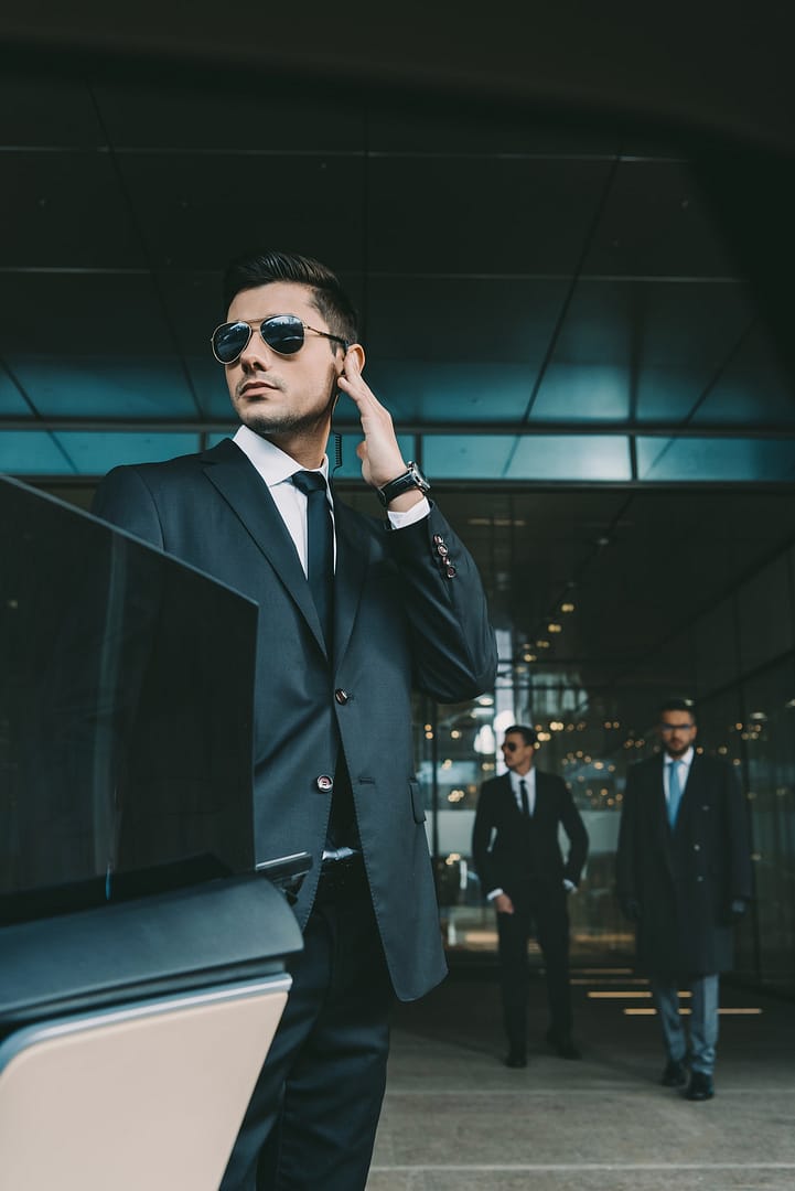 bodyguard-opening-car-door-for-businessman-and-listening-security-earpiece.jpg bodyguard-opening-car-door-for-businessman-and-listening-security-earpiece.jpg